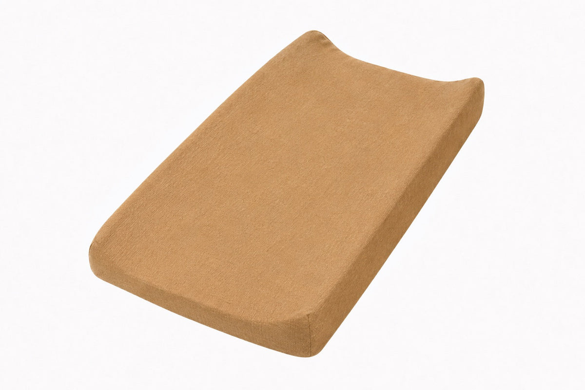 Solid brown changing pad cover fitted over a contoured changing pad