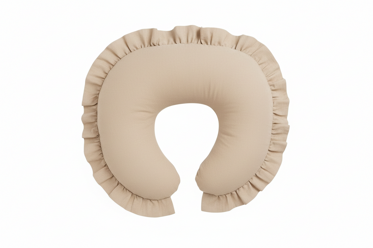 Beige nursing pillow cover with a ruffle trim edge, shaped to fit a standard curved feeding pillow.