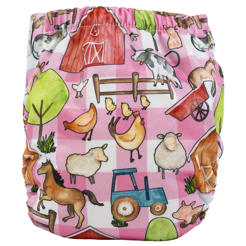 Tiny Tushies Newborn AIO Cloth Diaper with farm-themed print on pink background.