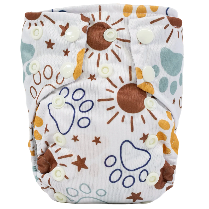 Tiny Tushies Newborn AIO Cloth Diaper with sun and paw print design.