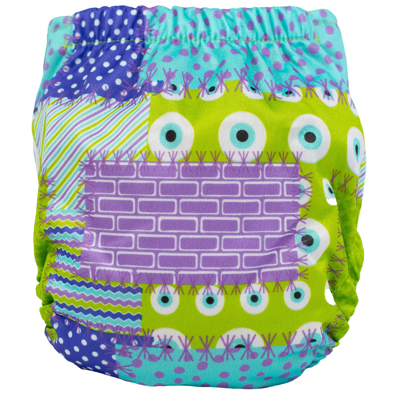 Tiny Tushies Newborn AIO Cloth Diaper with colorful patchwork design.