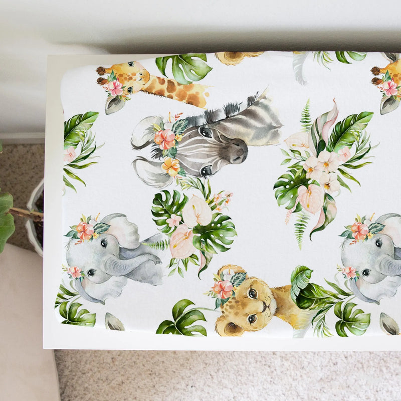 Changing pad cover with African animal designs and floral accents, made of soft and stretchy fabric.