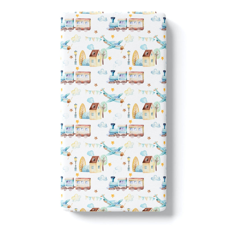 Fitted crib sheet with colorful airplane and train pattern.