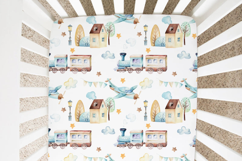 Fitted crib sheet with airplane and train pattern on standard size crib.