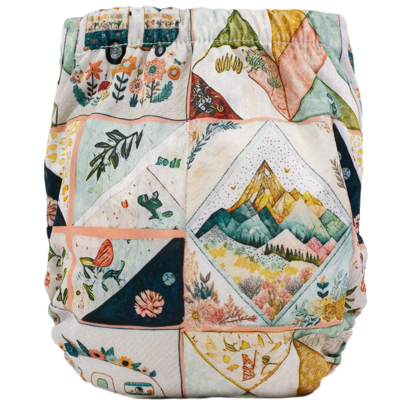 Tiny Tushies Newborn AIO cloth diaper with colorful printed design.