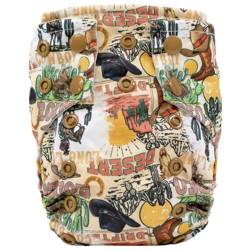 Tiny Tushies Newborn AIO Cloth Diaper with desert-themed print and secure snaps for adjustable fit.