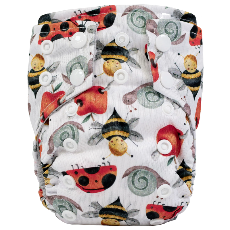 Tiny Tushies Newborn AIO Cloth Diaper with colorful animal print and secure snaps.
