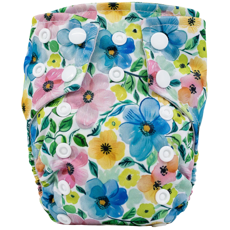 Tiny Tushies Newborn AIO Cloth Diaper with floral design and snaps for adjustable fit.