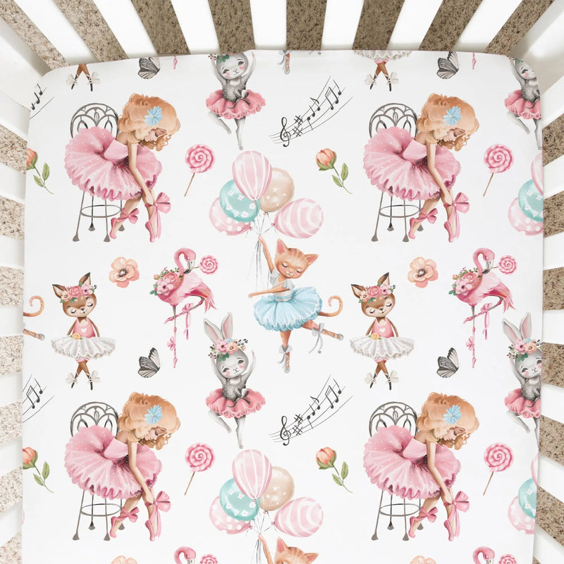 Fitted crib sheet with ballerina pattern featuring cats, flowers, and balloons in soft colors.