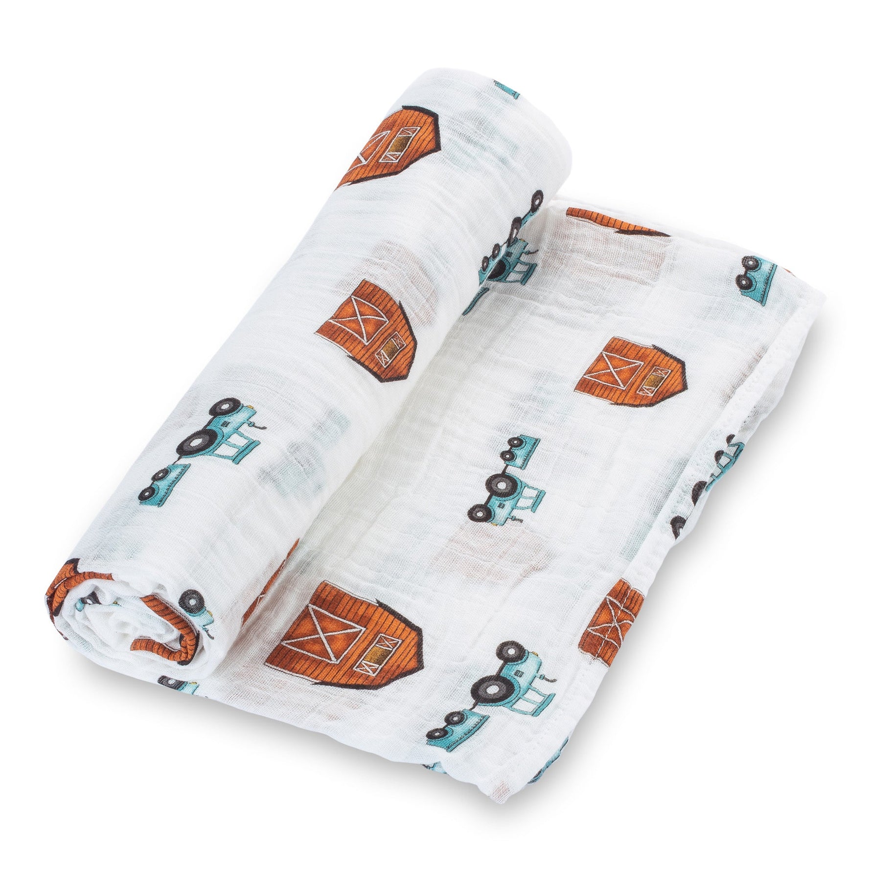 Organic cotton muslin swaddle blanket printed with tractors and barns, spread flat to show the farm design