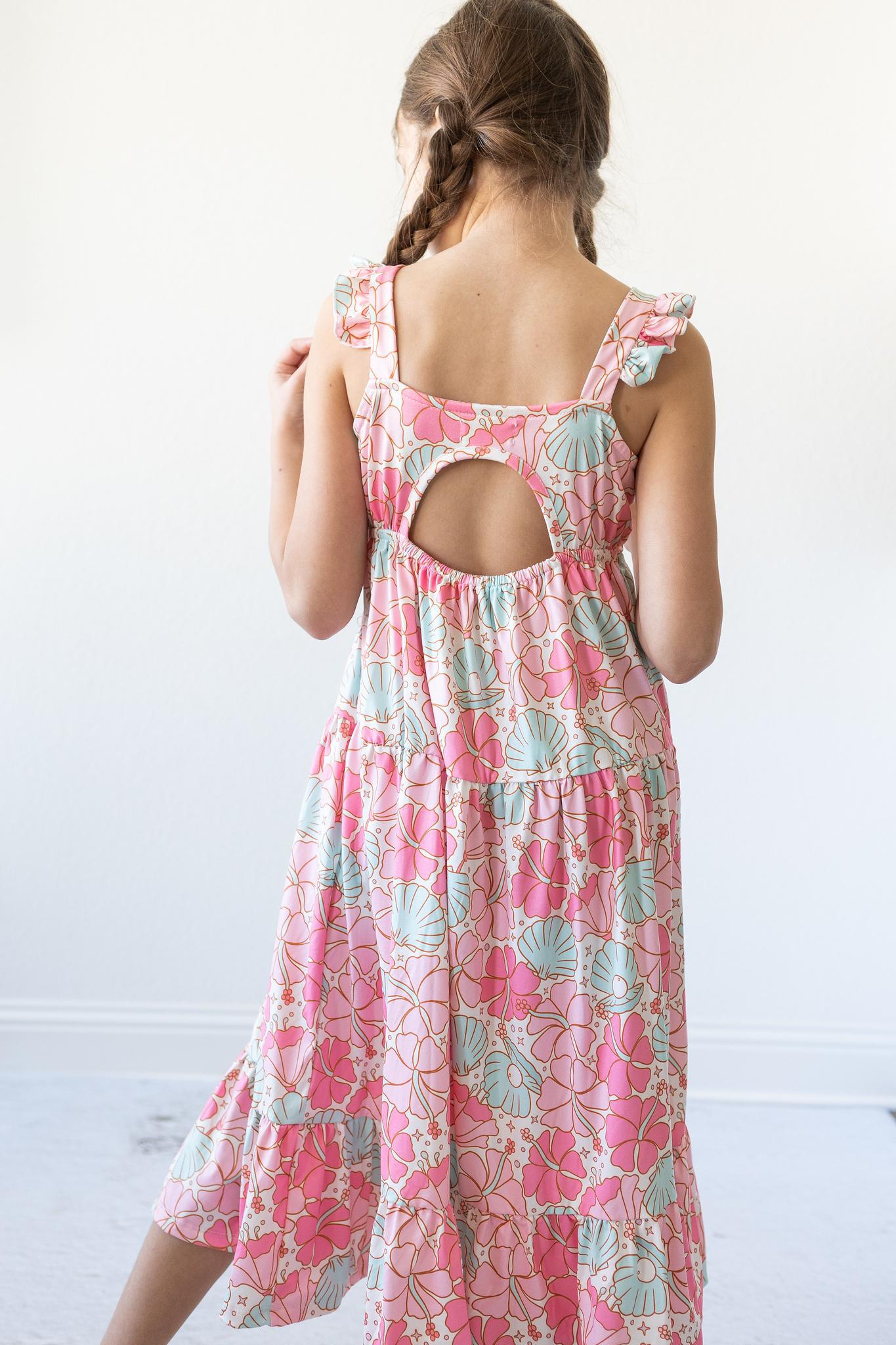 Ruffle maxi dress for girls with a shoulder ruffle and open back cutout in a summery print.