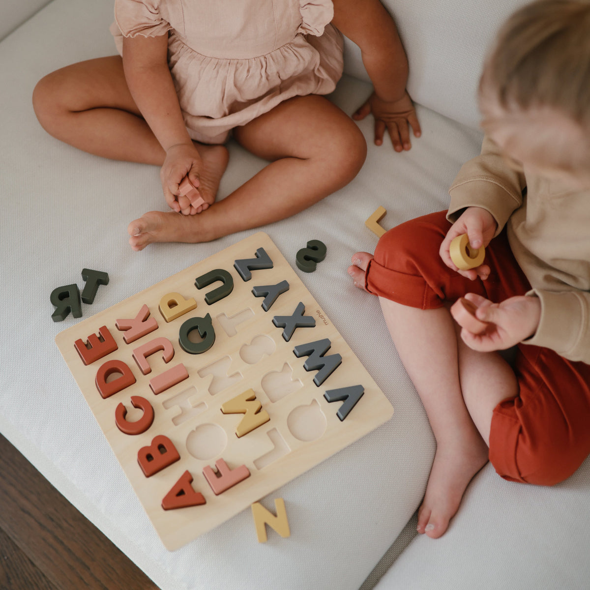 Mushie natural wood baby puzzle, educational shape sorter toy.