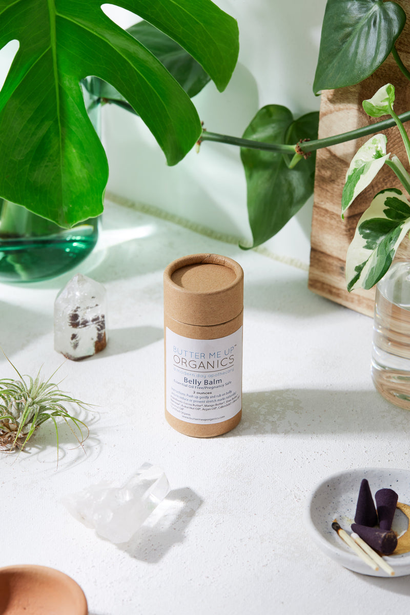 Organic pregnancy balm in eco-friendly packaging for stretch mark prevention.