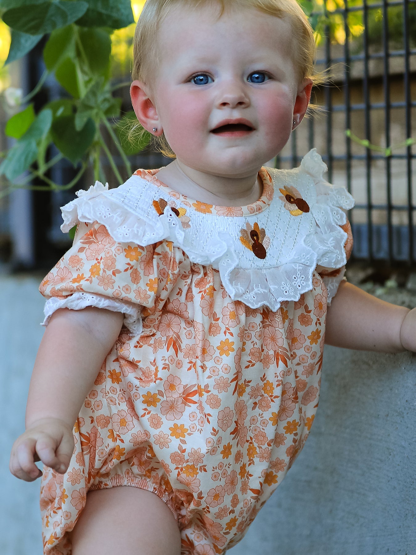 Girls bubble romper with turkey and floral print, lace ruffle neckline and puff sleeves