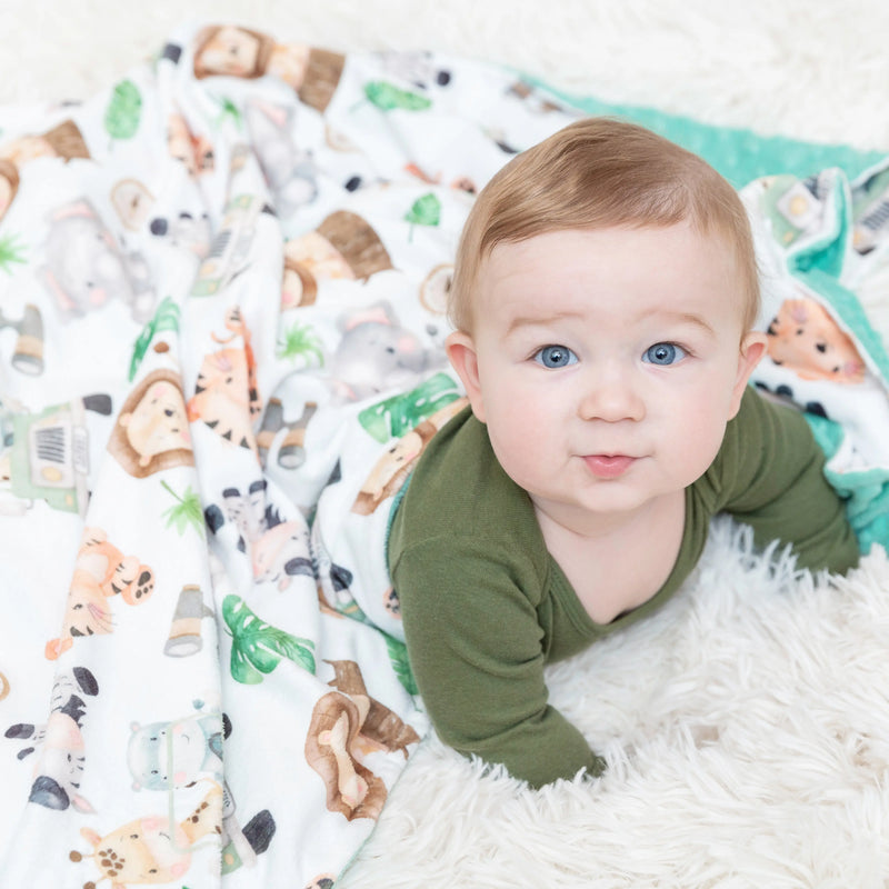 Premium baby & toddler minky blanket with vibrant safari pattern and minky dot texture, perfect for sensory stimulation and travel.