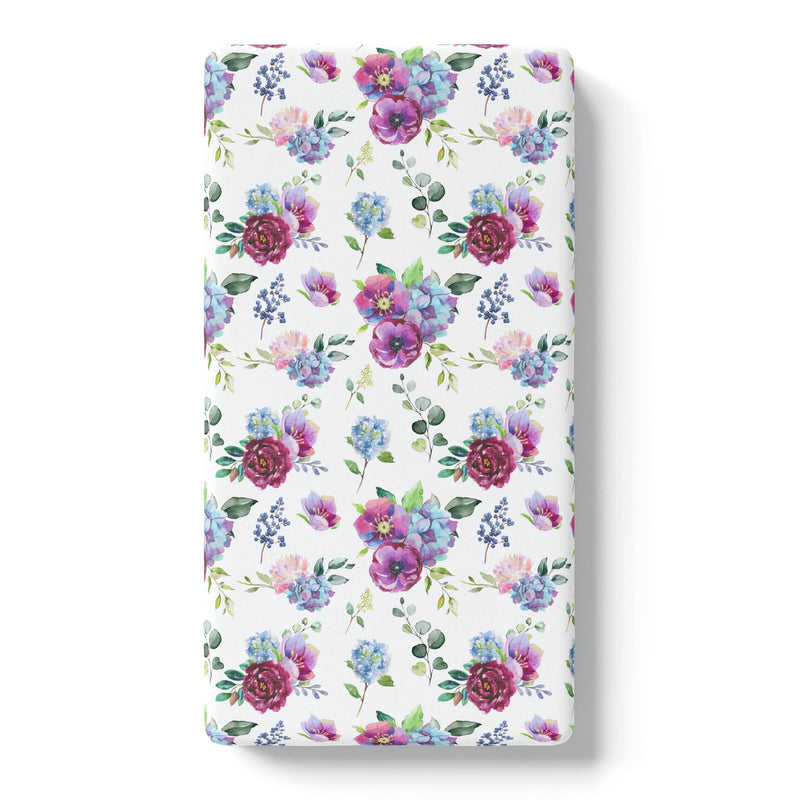 Blue floral fitted crib sheet with unique pattern for standard size crib.