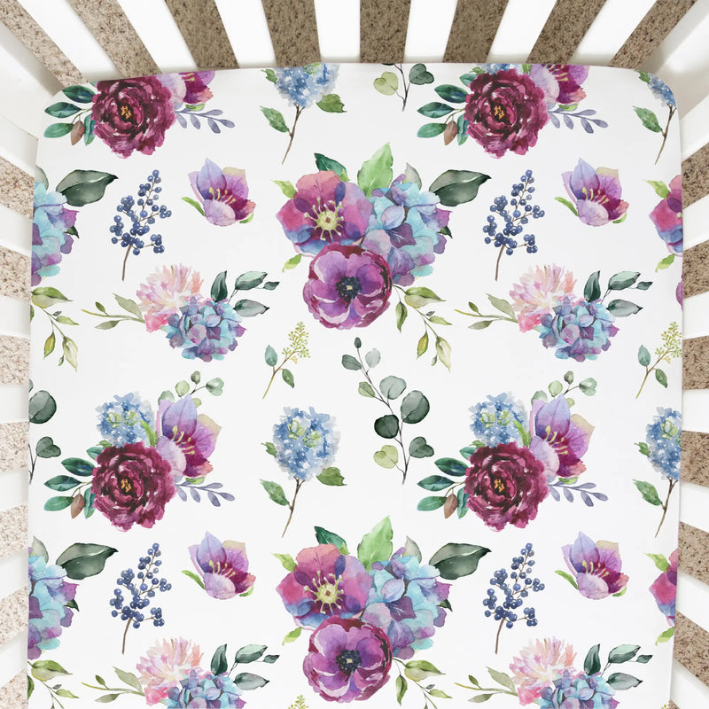 Fitted crib sheet in blue floral pattern.