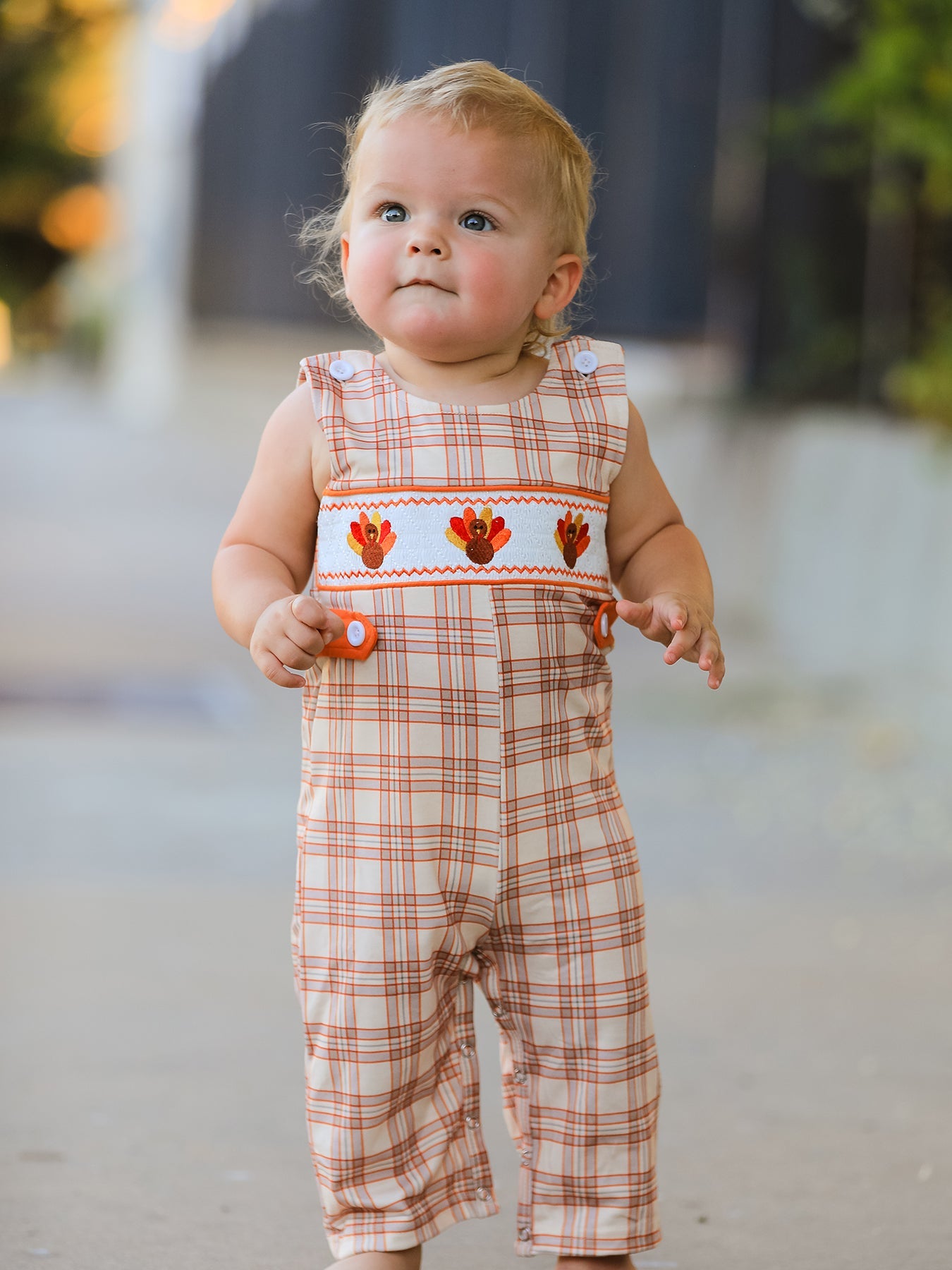 Baby JonJon romper in plaid print with embroidered turkey details, button shoulder straps and snap closures