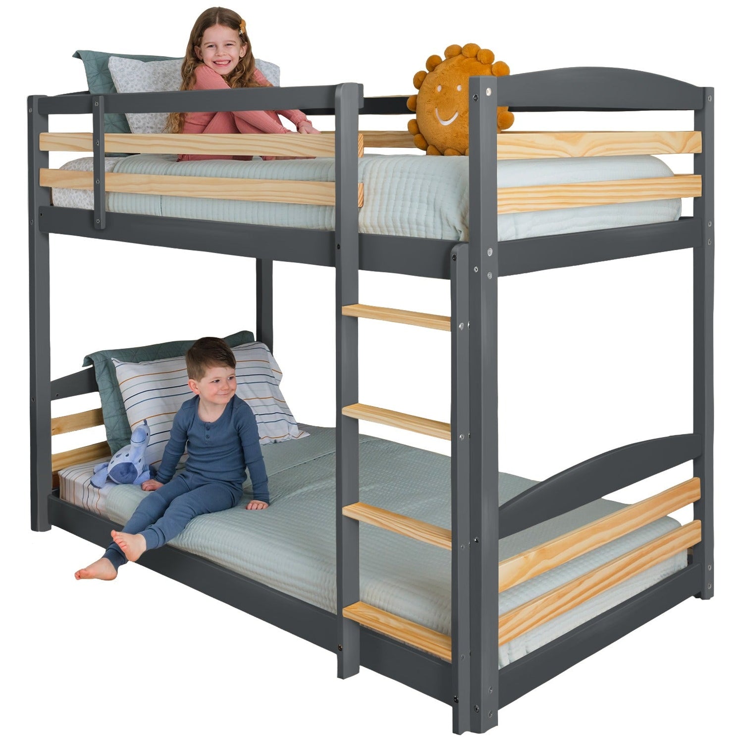 Solid wood twin-over-twin bunk bed with natural finish, ladder, and high guard rails on both bunks.