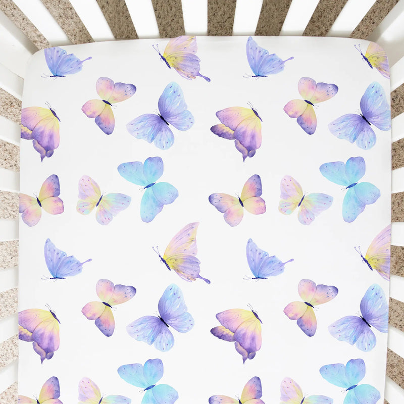 Fitted crib sheet with colorful butterfly pattern.
