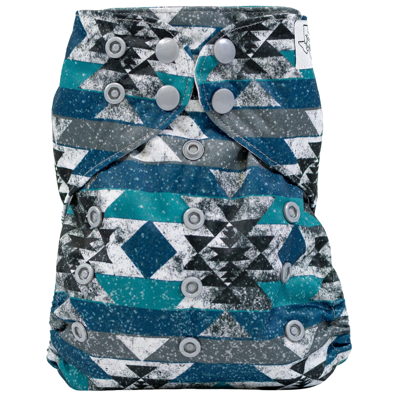 Slim fit pocket cloth diaper with geometric pattern and adjustable snaps.