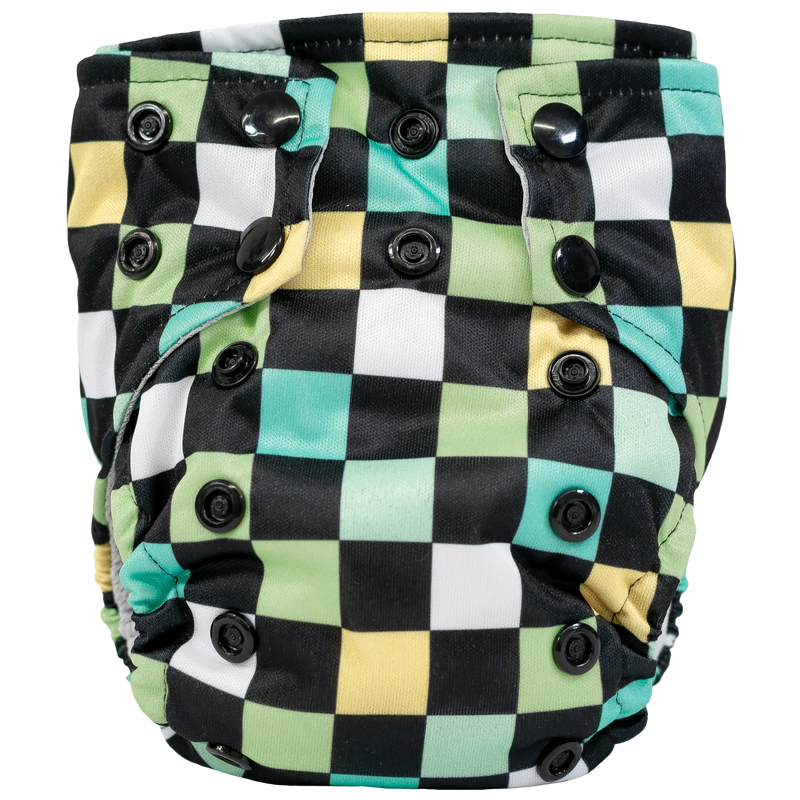 Tiny Tushies Newborn AIO cloth diaper with colorful checkered pattern and secure snaps.