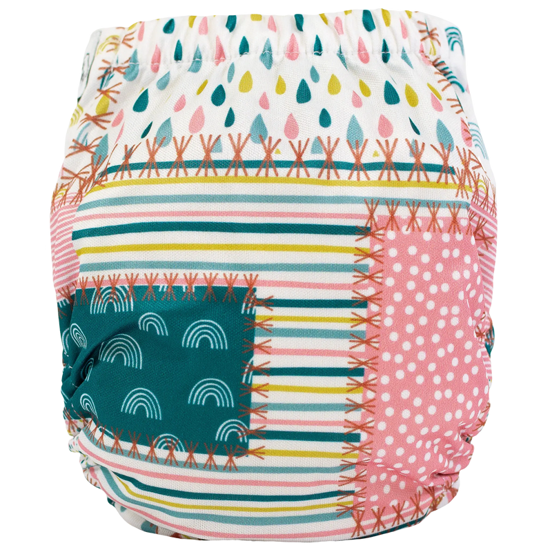 Tiny Tushies Newborn AIO Cloth Diaper with colorful patchwork design.