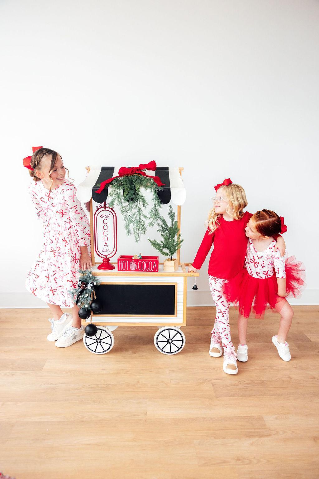 Mila & Rose Candy Cane Lane organic baby leggings with festive candy cane print.
