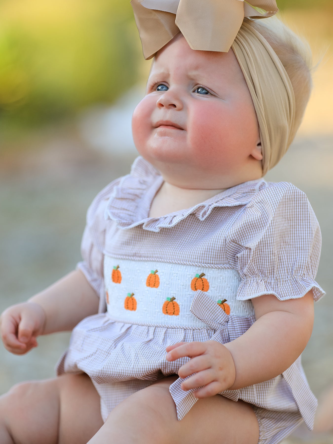 Baby girl romper in plaid with pumpkin embroidery and a smocked front bodice