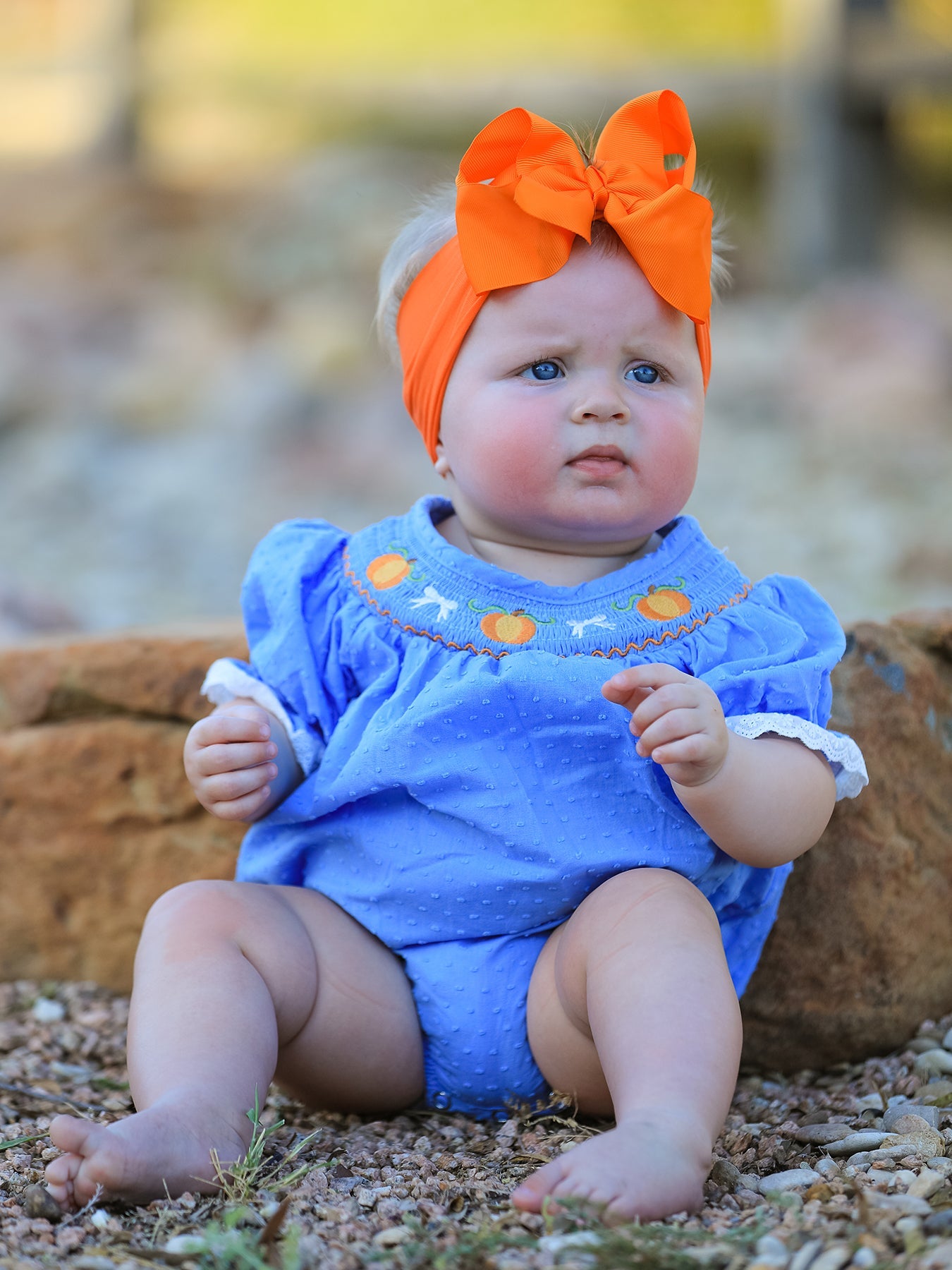 Bubble romper with pumpkin embroidery, smocked detailing, puff sleeves, and lace trim