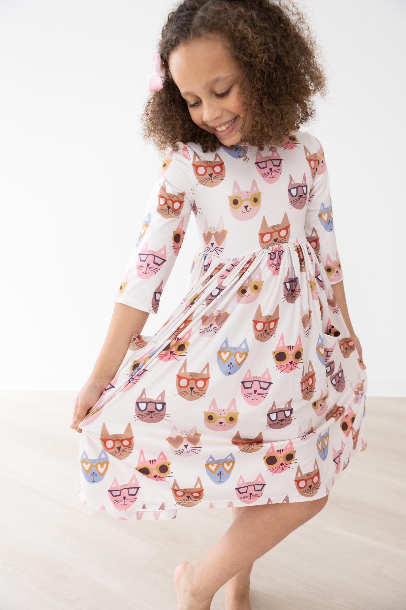 Twirl dress with 3/4 sleeves, cat print, pockets, ballet neckline, and a full skirt.