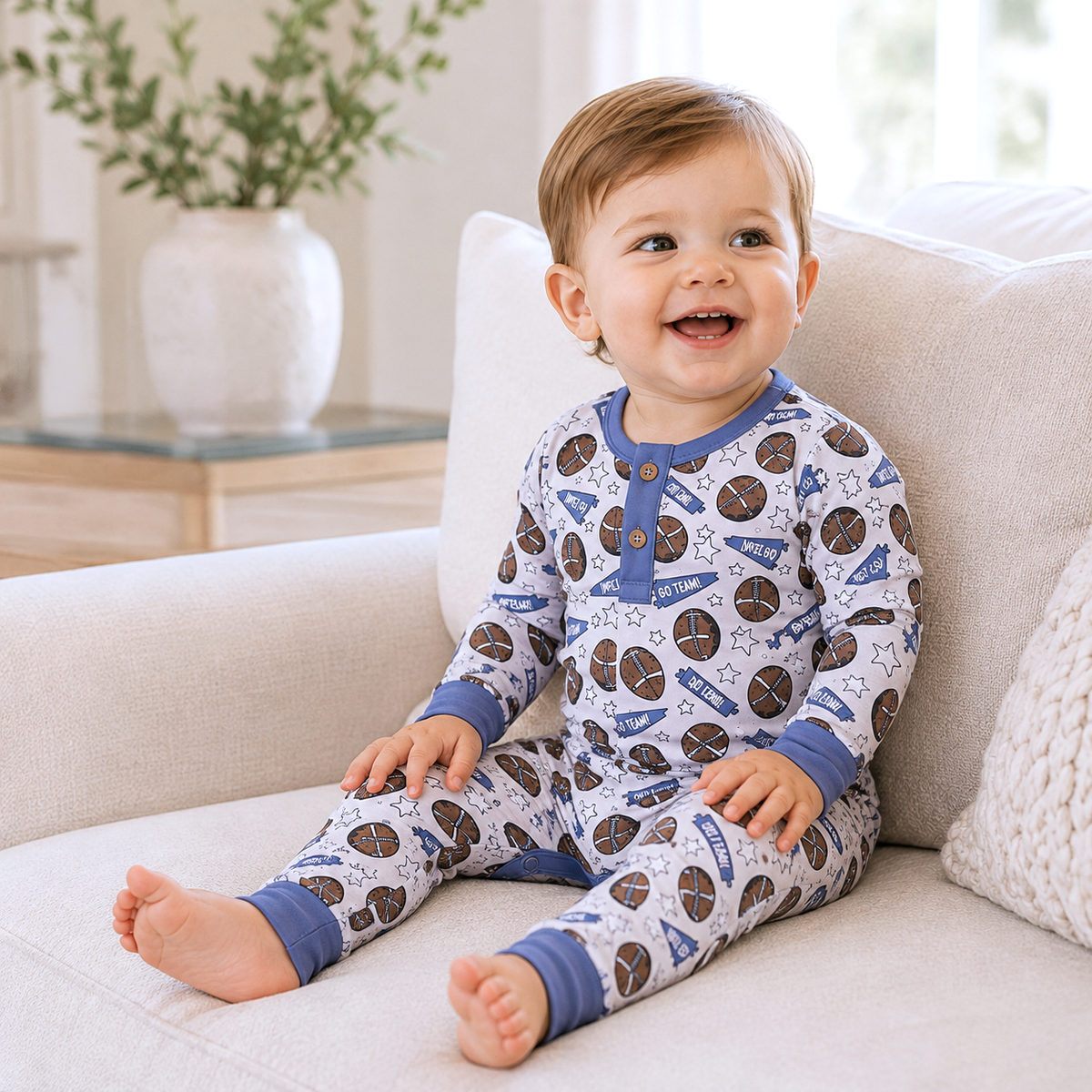 Baby romper with a football print and Henley button front