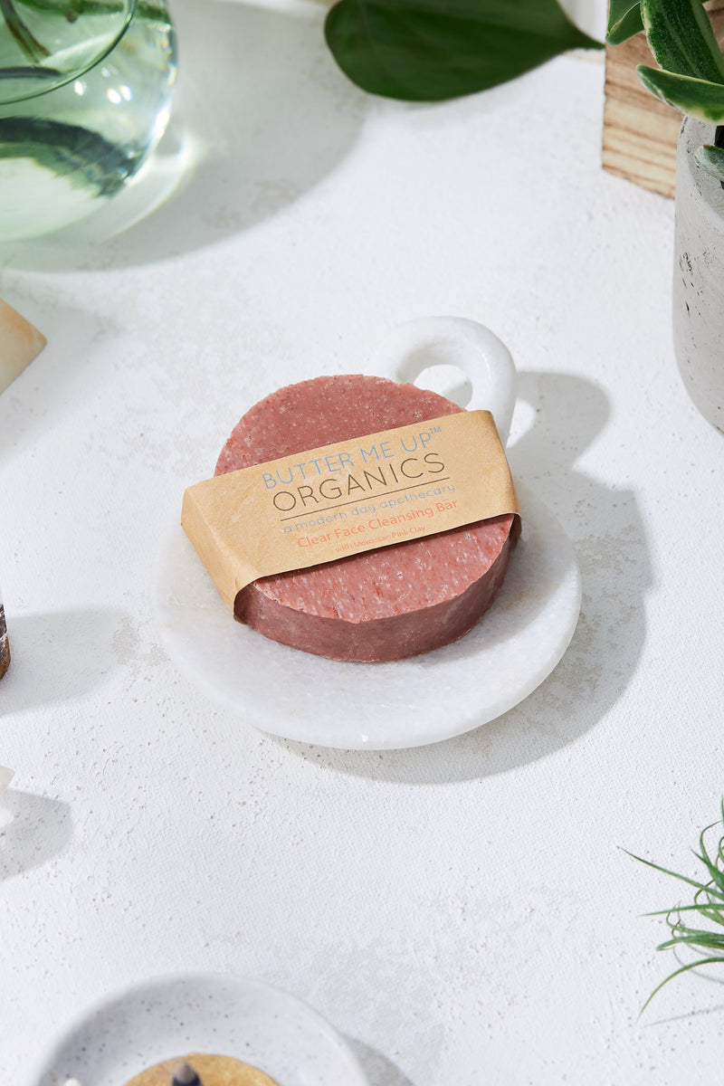 Organic Facial Bar with rose kaolin clay on a white dish, eco-friendly packaging.