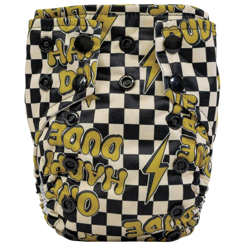 Tiny Tushies Newborn AIO cloth diaper with black and white checkered pattern and yellow text design.