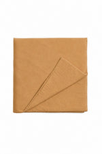 Solid brown quilted crib blanket with hand-tufted stitching, shown spread flat