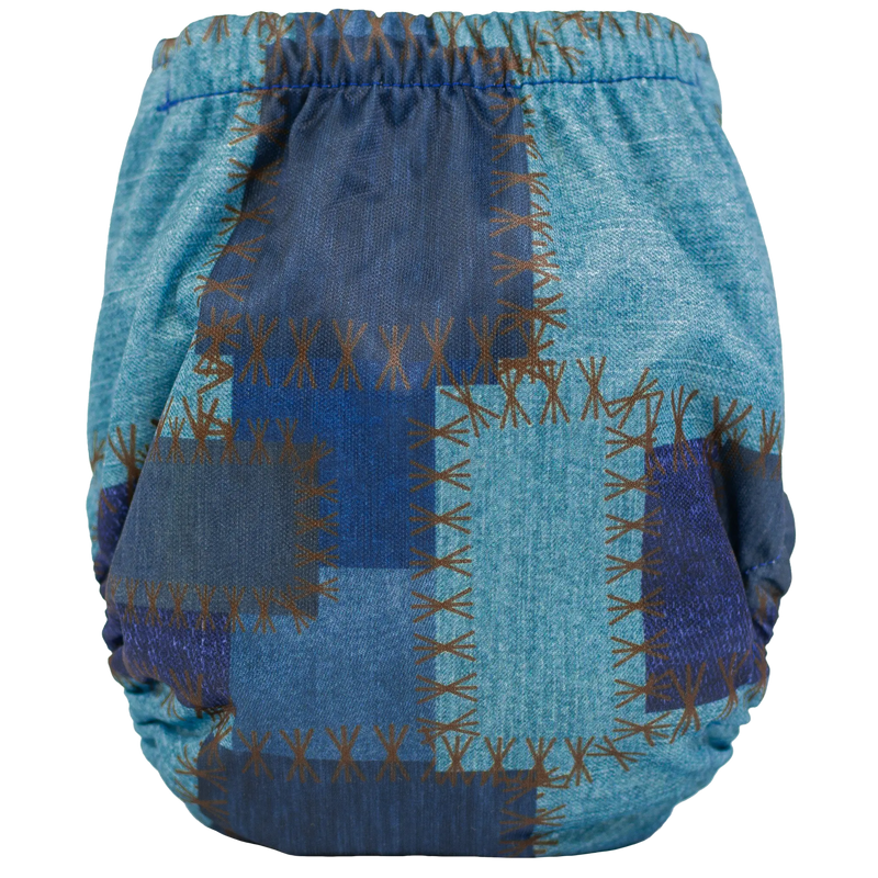 Tiny Tushies Newborn AIO Cloth Diaper with blue plaid design and snug fit.