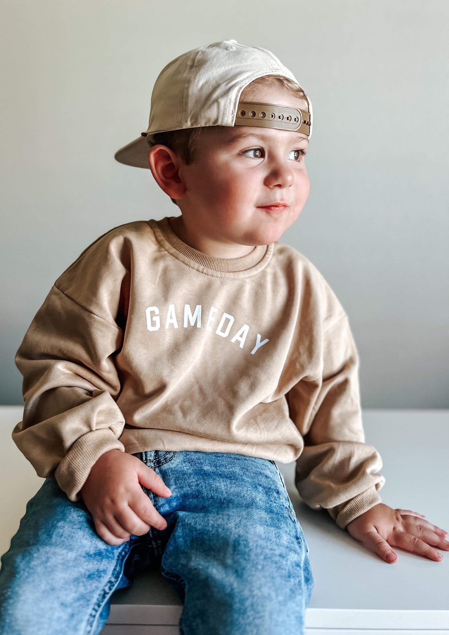 Camel crewneck sweatshirt with a gameday football graphic printed on the front
