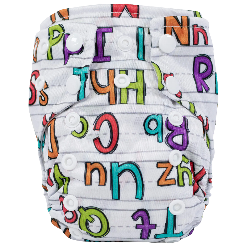 Tiny Tushies Newborn AIO Cloth Diaper with colorful alphabet print and secure snaps.