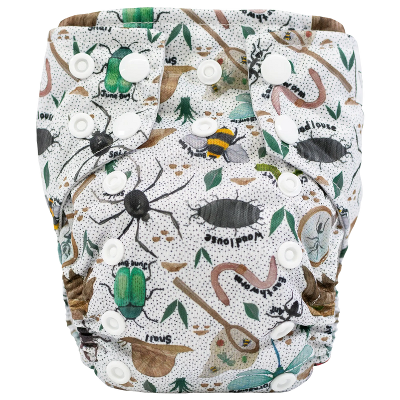 Tiny Tushies Newborn AIO Cloth Diaper with insect and nature print, featuring dirty closure snaps and pocket opening.