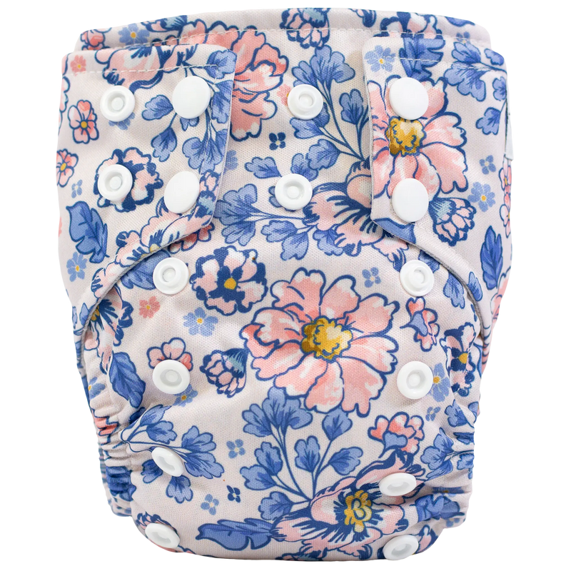 Tiny Tushies Newborn AIO cloth diaper with floral print and secure snaps.