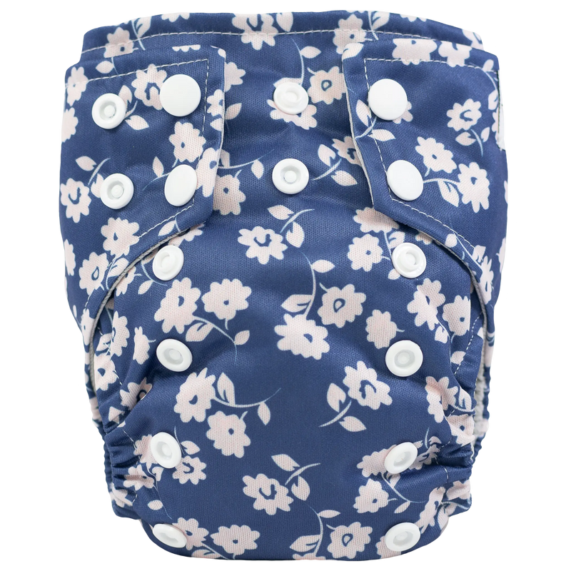 Tiny Tushies Newborn AIO Cloth Diaper with floral print and adjustable snaps.