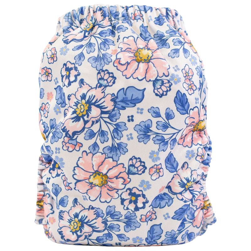 Slim fit pocket cloth diaper with floral pattern, suitable for babies 8-40lbs, featuring a wide pocket opening and tummy panels.