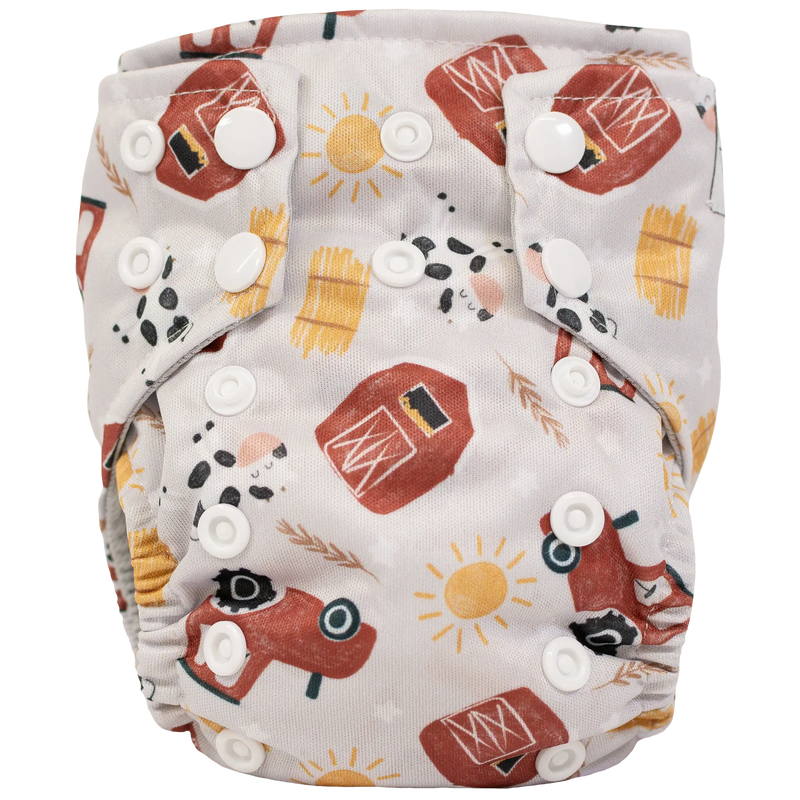Tiny Tushies Newborn AIO Cloth Diaper with farm theme pattern and adjustable snaps.