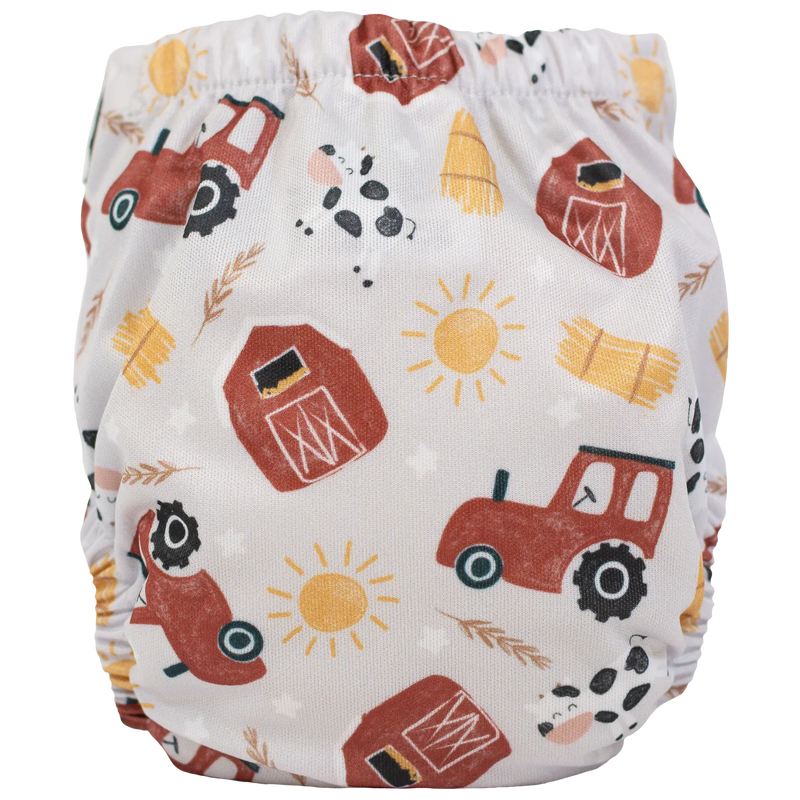 Tiny Tushies Newborn AIO Cloth Diaper with farm-themed print, featuring tractors and barns.