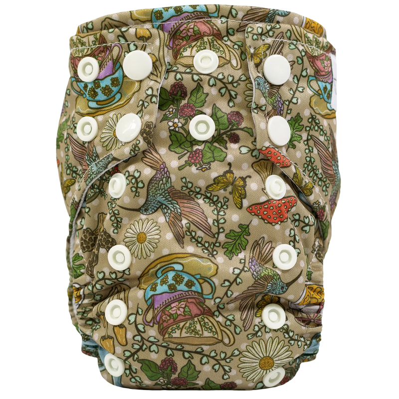Tiny Tushies Newborn AIO cloth diaper in floral print with secure snaps and pocket opening.