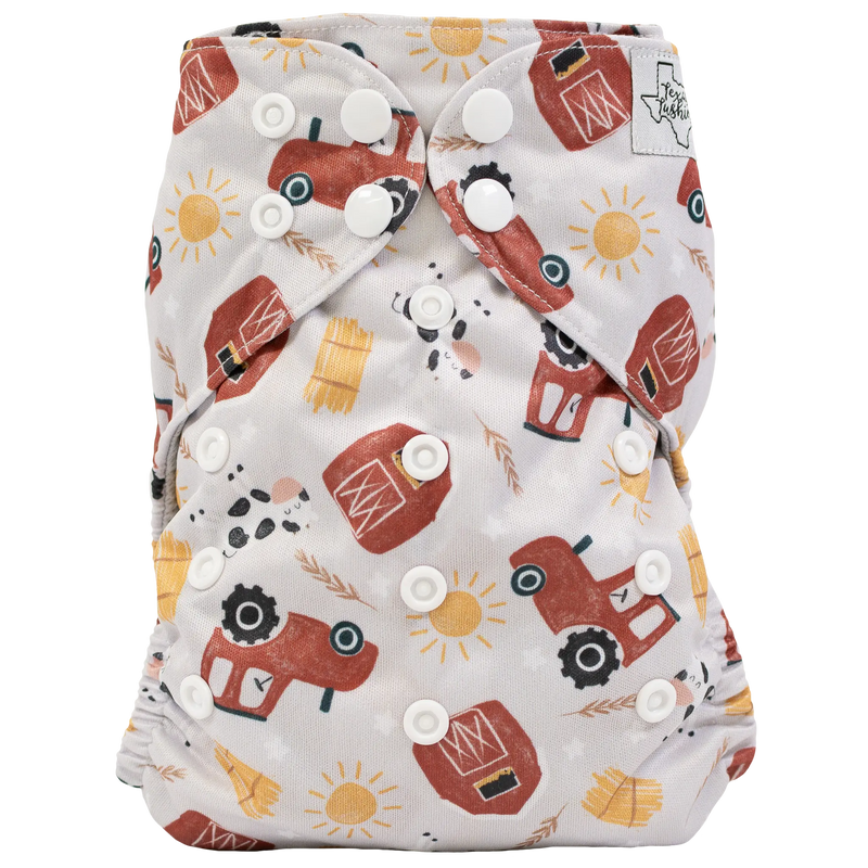 Slim Fit Pocket Cloth Diaper with tractor print and adjustable snaps for babies 8-40lbs.