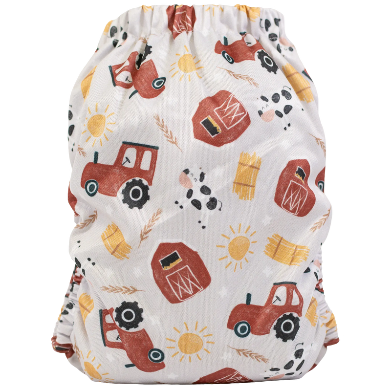 Slim fit pocket cloth diaper with farm-themed print, featuring tractors and barns.
