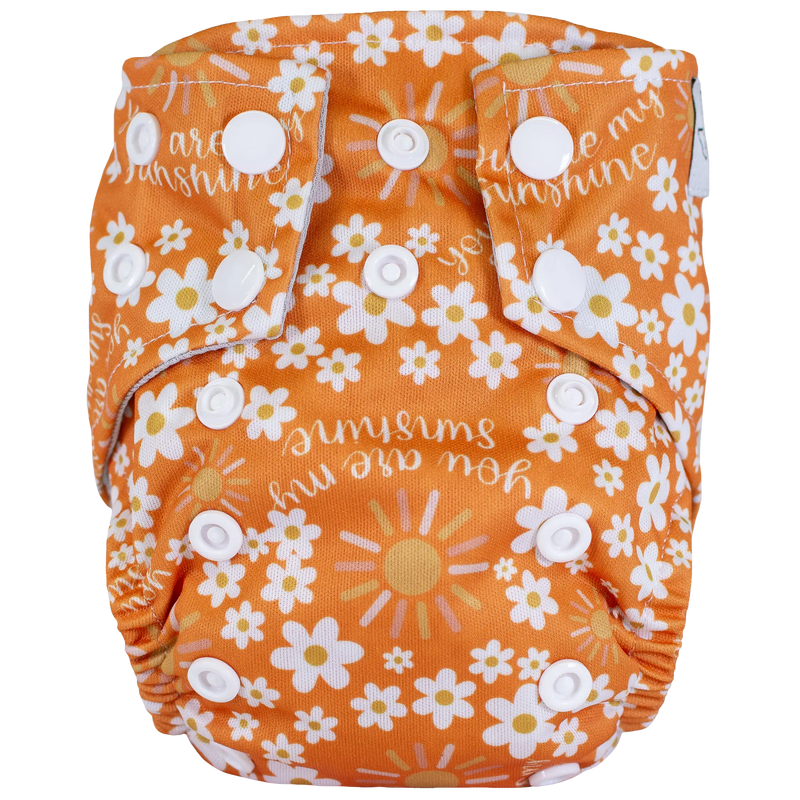 Tiny Tushies Newborn AIO Cloth Diaper with floral pattern and snaps.