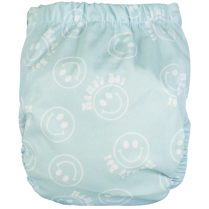 Tiny Tushies Newborn AIO Cloth Diaper with smiley face pattern and secure closure snaps.