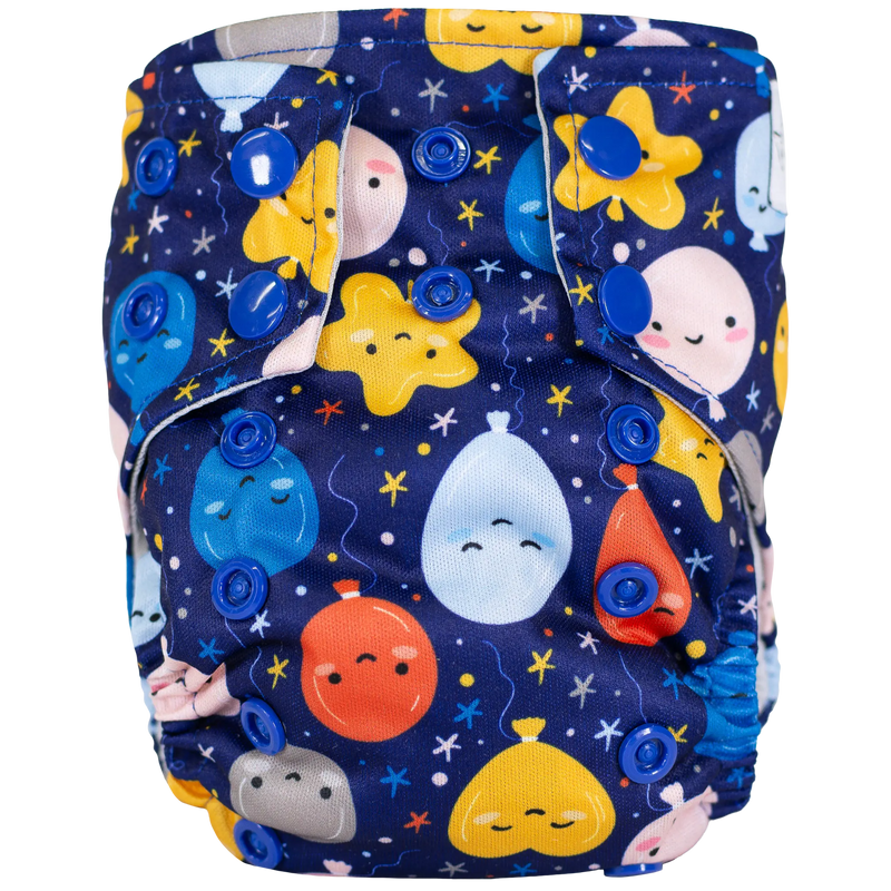Tiny Tushies Newborn AIO Cloth Diaper with colorful print and blue snaps.